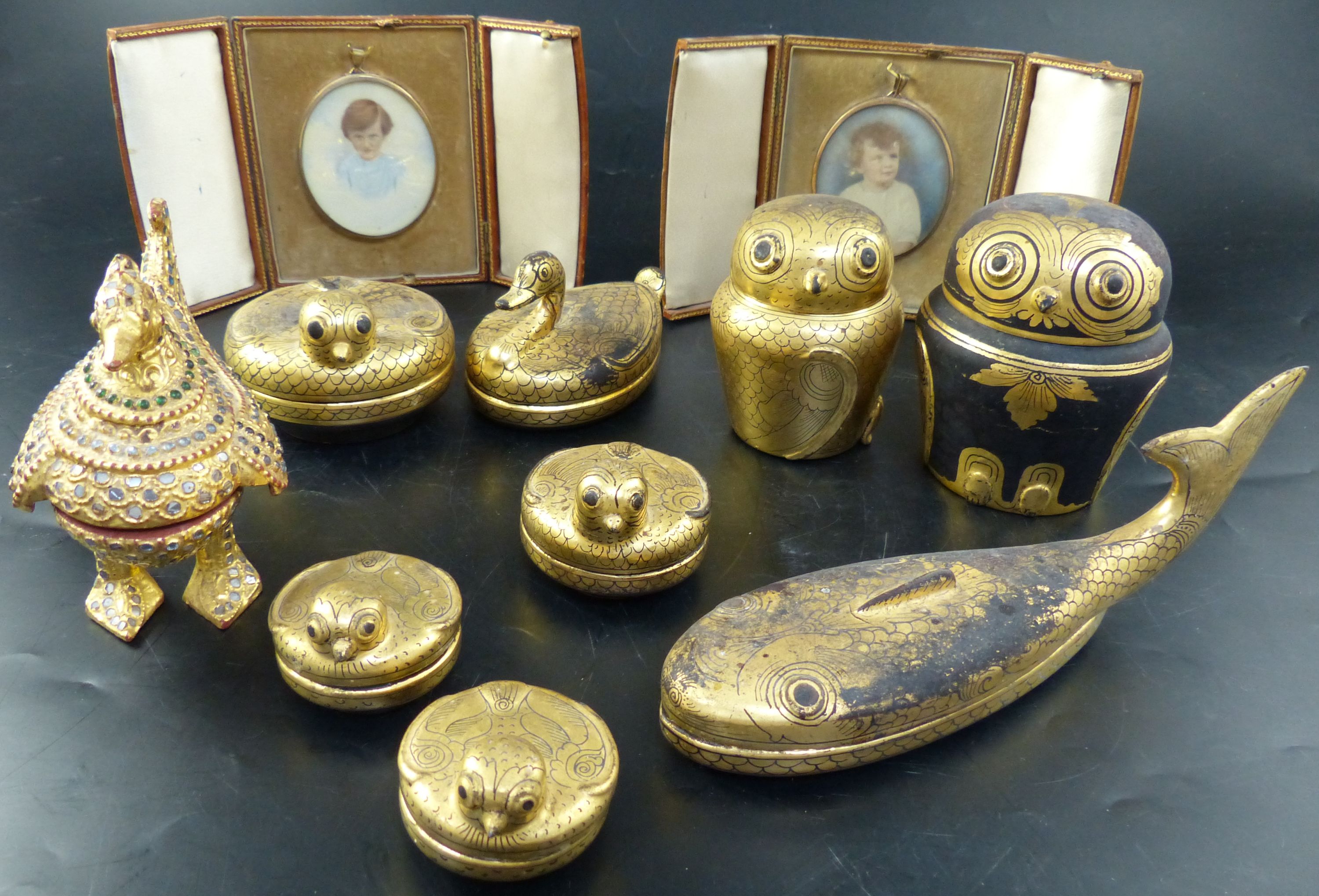 Two colour tinted miniature photographs of an infant boy and girl, cased and a collection of Asian gilt lacquer boxes and animal figure